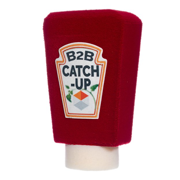 Red foam microphone cover with a ketchup-label-style design reading "B2B Catch-Up."