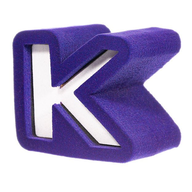 Foam microphone cover in the shape of a bold purple "K" with a white interior.